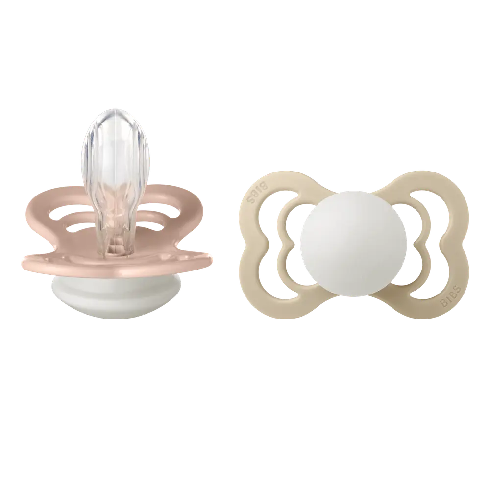 Napp Supreme Glow 2-pack Silikon Symmetrisk 6-18 mån- Blush/Vanilla | Baby & Barn - Sköta - Nappar | BabyMode